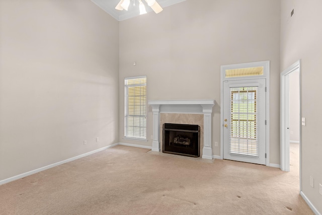 6276 Amber Brook Dr, Hixson, TN 37343 - unfurnished living room with a high ceiling, a ceiling fan, carpet, a tile fireplace, and ornamental molding