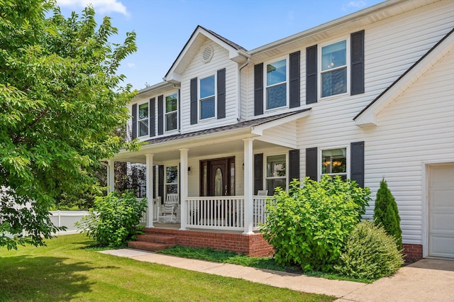 7470 Jester Ct, Ooltewah, TN 37363 - view of front facade with covered porch, a garage, and a front lawn