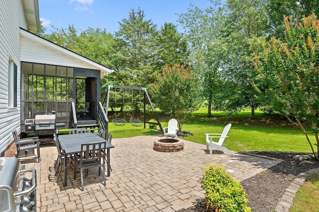 7470 Jester Ct, Ooltewah, TN 37363 - view of patio / terrace with an outdoor fire pit, a sunroom, a playground, outdoor dining area, and view of wooded area