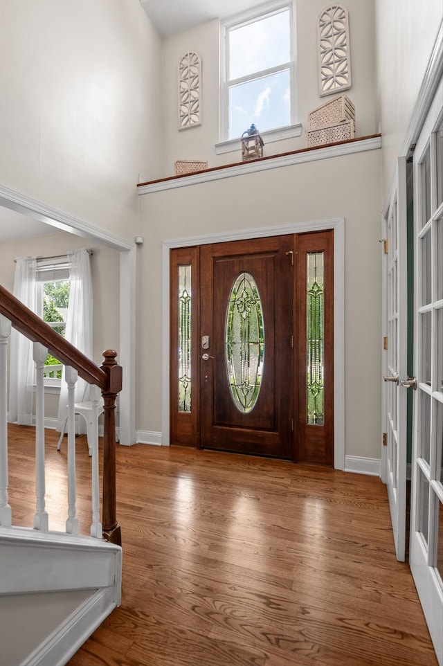 7470 Jester Ct, Ooltewah, TN 37363 - entrance foyer featuring a high ceiling, wood finished floors, and stairs