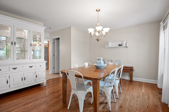 7470 Jester Ct, Ooltewah, TN 37363 - dining room with a chandelier and light wood-type flooring