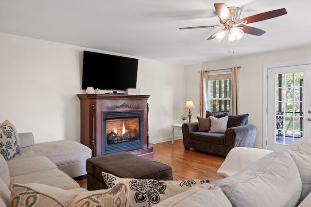 7470 Jester Ct, Ooltewah, TN 37363 - living area with wood finished floors, a warm lit fireplace, and ceiling fan