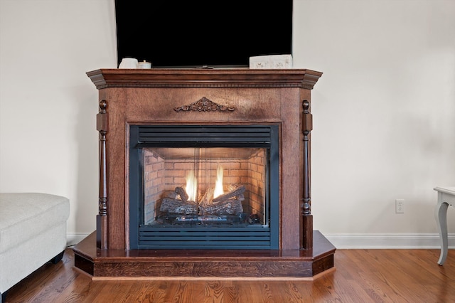 7470 Jester Ct, Ooltewah, TN 37363 - detailed view of wood finished floors and a warm lit fireplace