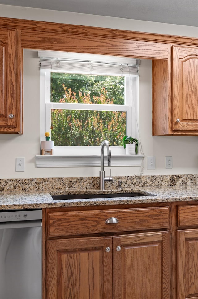 7470 Jester Ct, Ooltewah, TN 37363 - kitchen with dishwasher, brown cabinetry, and light stone counters