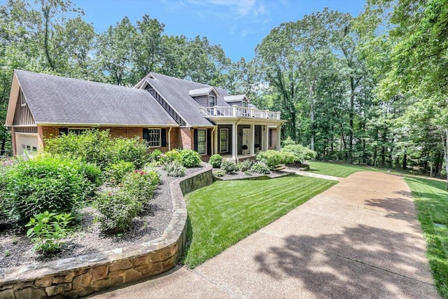 5 Woodland Way, Chattanooga, TN 37419 - view of front facade featuring brick siding, a front yard, an attached garage, and a balcony