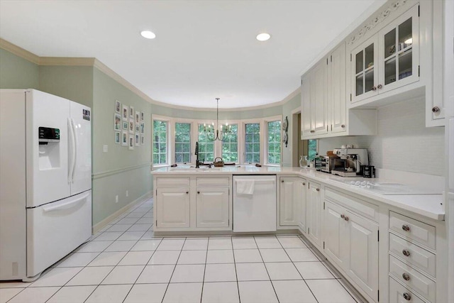 5 Woodland Way, Chattanooga, TN 37419 - kitchen featuring white appliances, a peninsula, crown molding, light countertops, and glass insert cabinets