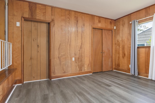 4412 Live Oak Ln, Chattanooga, TN 37411 - unfurnished bedroom with wood finished floors, wooden walls, and a closet