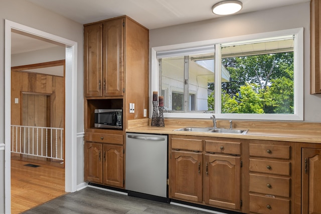 4412 Live Oak Ln, Chattanooga, TN 37411 - kitchen with stainless steel appliances, light countertops, dark wood finished floors, and brown cabinetry