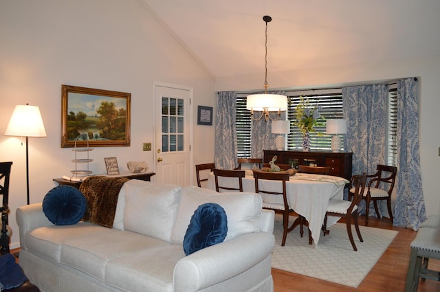 8211 Troubadour Way, Ooltewah, TN 37363 - living room with a chandelier, wood finished floors, and high vaulted ceiling