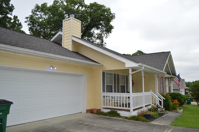 8211 Troubadour Way, Ooltewah, TN 37363 - view of side of home featuring covered porch, roof with shingles, a chimney, concrete driveway, and an attached garage