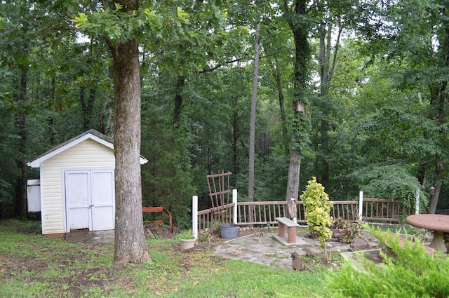 8211 Troubadour Way, Ooltewah, TN 37363 - view of yard featuring a shed and a wooded view