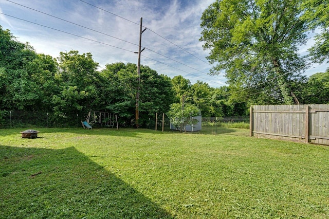 1209 Hickory Ave, South Pittsburg, TN 37380 - fenced backyard with a fire pit and a playground