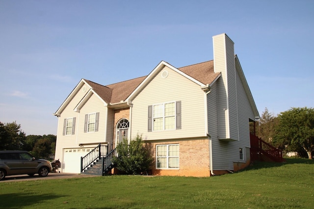140 Chestnut Ln SE, Calhoun, GA 30701 - raised ranch with brick siding, a chimney, a garage, a front lawn, and driveway
