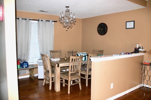 140 Chestnut Ln SE, Calhoun, GA 30701 - dining room featuring wood finished floors, a textured ceiling, and a chandelier