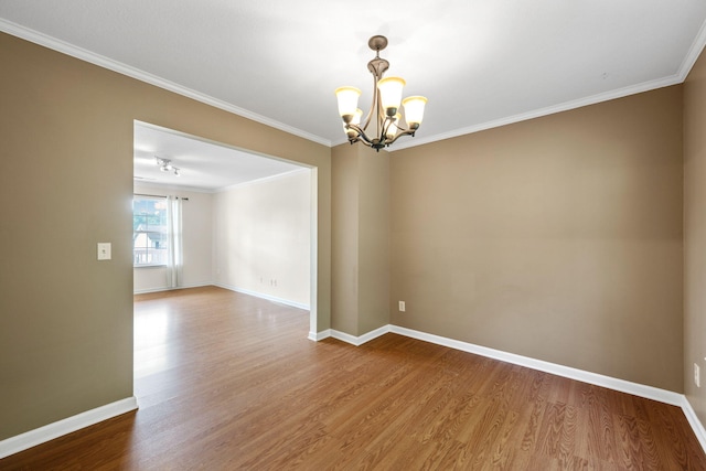 4429 Kayla Cir, Chattanooga, TN 37406 - spare room featuring a chandelier, wood finished floors, and crown molding