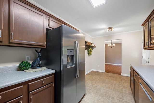 4429 Kayla Cir, Chattanooga, TN 37406 - kitchen featuring appliances with stainless steel finishes, crown molding, a chandelier, light countertops, and dark brown cabinets