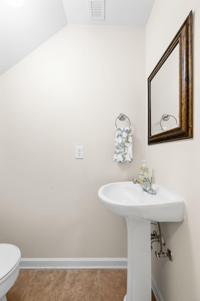 4429 Kayla Cir, Chattanooga, TN 37406 - half bathroom featuring vaulted ceiling and tile patterned flooring