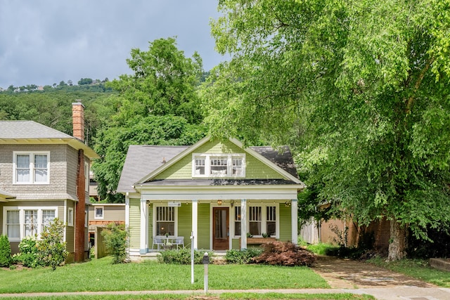 4503 Saint Elmo Ave, Chattanooga, TN 37409 - view of front of home with covered porch, a front yard, and a chimney