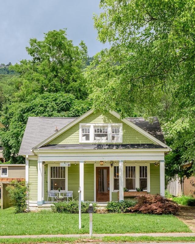 4503 Saint Elmo Ave, Chattanooga, TN 37409 - view of front facade with a porch, a front lawn, and a shingled roof