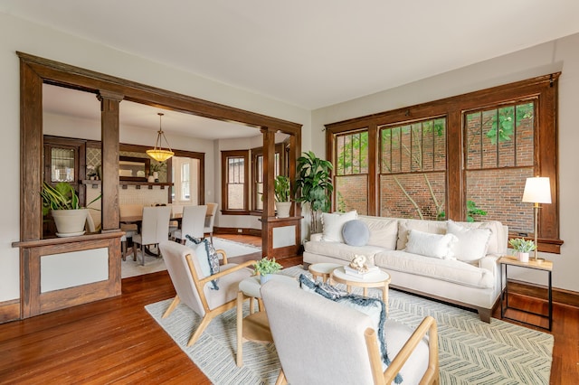 4503 Saint Elmo Ave, Chattanooga, TN 37409 - living room with ornate columns, wood finished floors, and plenty of natural light