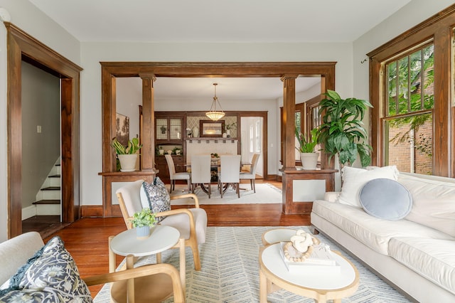 4503 Saint Elmo Ave, Chattanooga, TN 37409 - living room featuring wood finished floors, stairway, and decorative columns