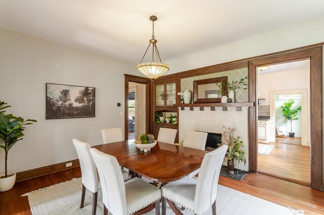 4503 Saint Elmo Ave, Chattanooga, TN 37409 - dining room with wood finished floors and a brick fireplace