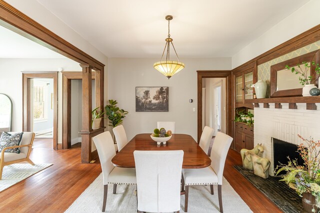 4503 Saint Elmo Ave, Chattanooga, TN 37409 - dining room featuring wood finished floors and a brick fireplace
