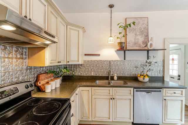 4503 Saint Elmo Ave, Chattanooga, TN 37409 - kitchen featuring stainless steel appliances, cream cabinetry, under cabinet range hood, dark countertops, and tasteful backsplash