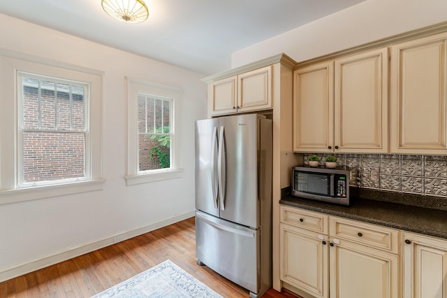 4503 Saint Elmo Ave, Chattanooga, TN 37409 - kitchen featuring cream cabinets, stainless steel appliances, light wood-type flooring, and dark countertops