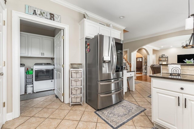 234 Holcomb Rd, Ringgold, GA 30736 - kitchen with stainless steel fridge with ice dispenser, arched walkways, washing machine and clothes dryer, white cabinetry, and dark stone countertops