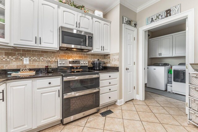 234 Holcomb Rd, Ringgold, GA 30736 - kitchen featuring appliances with stainless steel finishes, ornamental molding, dark countertops, and white cabinetry
