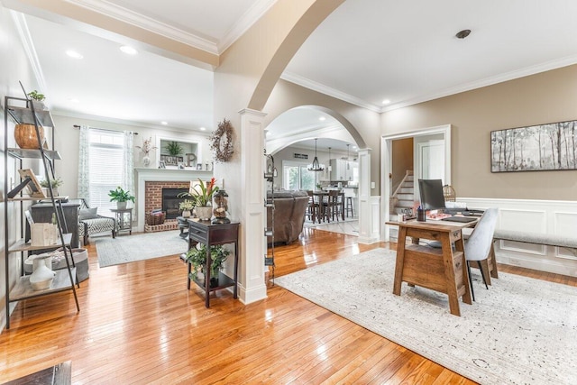 234 Holcomb Rd, Ringgold, GA 30736 - office featuring arched walkways, ornate columns, light wood-style flooring, a brick fireplace, and crown molding