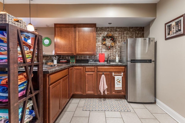 234 Holcomb Rd, Ringgold, GA 30736 - kitchen with freestanding refrigerator, backsplash, brown cabinetry, and dark countertops