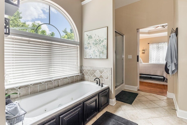 234 Holcomb Rd, Ringgold, GA 30736 - ensuite bathroom featuring healthy amount of natural light, a whirlpool tub, a shower stall, a towering ceiling, and tile patterned flooring