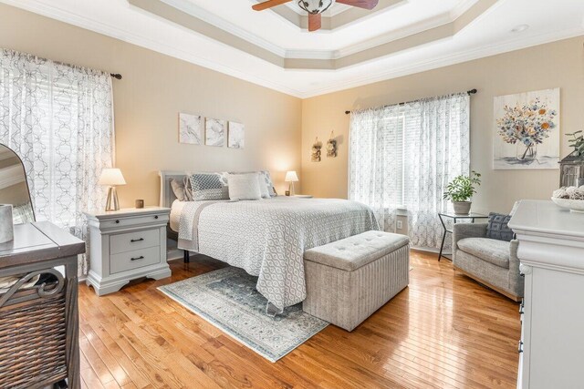234 Holcomb Rd, Ringgold, GA 30736 - bedroom with ornamental molding, light wood-type flooring, a tray ceiling, and a ceiling fan