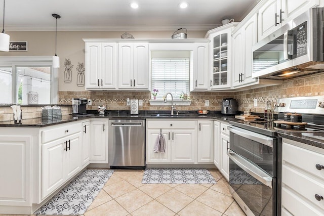 234 Holcomb Rd, Ringgold, GA 30736 - kitchen featuring appliances with stainless steel finishes, a peninsula, ornamental molding, tasteful backsplash, and white cabinetry