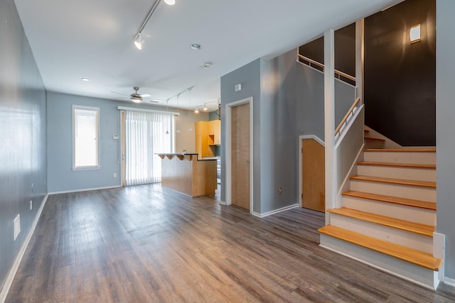277 W 19th St, Chattanooga, TN 37408 - unfurnished living room with rail lighting, a ceiling fan, wood finished floors, and stairway