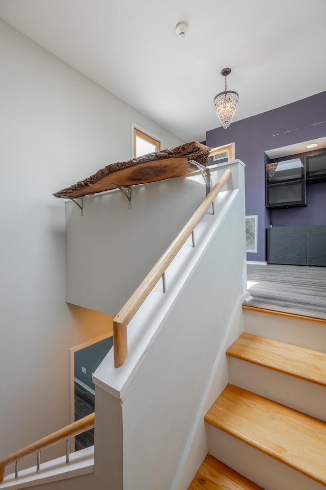 277 W 19th St, Chattanooga, TN 37408 - staircase with wood finished floors and a chandelier