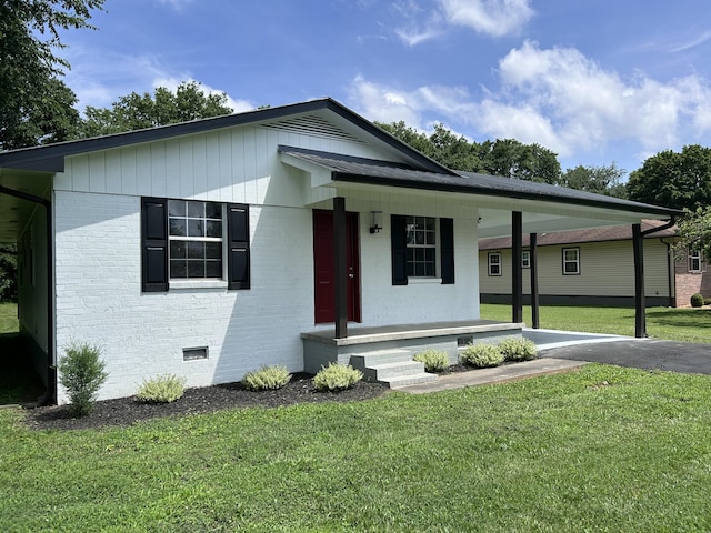 4594 Lee Dr NW, Cleveland, TN 37312 - view of front of home with a porch, a carport, brick siding, a front yard, and crawl space