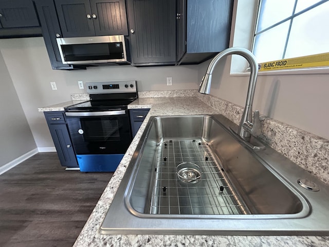 4594 Lee Dr NW, Cleveland, TN 37312 - kitchen with stainless steel microwave, black range with electric cooktop, dark wood finished floors, and light countertops