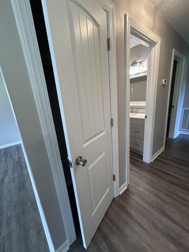 4594 Lee Dr NW, Cleveland, TN 37312 - corridor featuring dark wood-style flooring and a textured ceiling