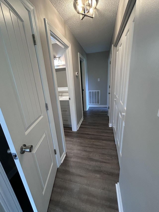 4594 Lee Dr NW, Cleveland, TN 37312 - hallway with dark wood-type flooring and a textured ceiling