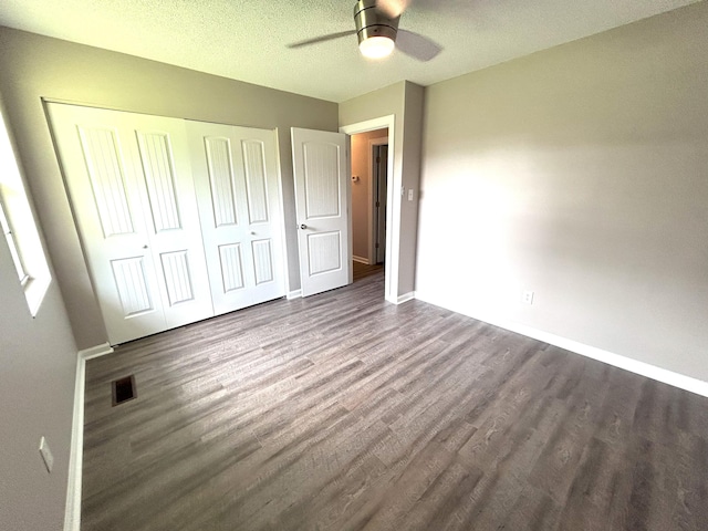 4594 Lee Dr NW, Cleveland, TN 37312 - unfurnished bedroom with wood finished floors, a closet, ceiling fan, and a textured ceiling