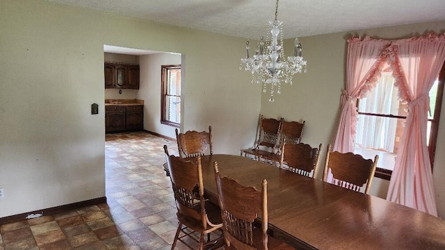 271 Anderson Rd, Palmer, TN 37365 - dining area with a chandelier, stone finish flooring, and a textured ceiling