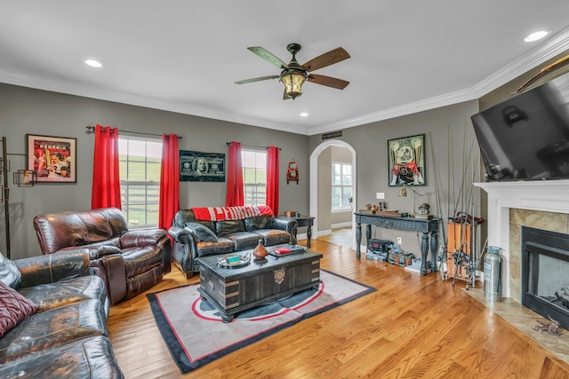 231 Turkey Run, Flintstone, GA 30725 - living room with arched walkways, a ceiling fan, wood finished floors, a tiled fireplace, and crown molding