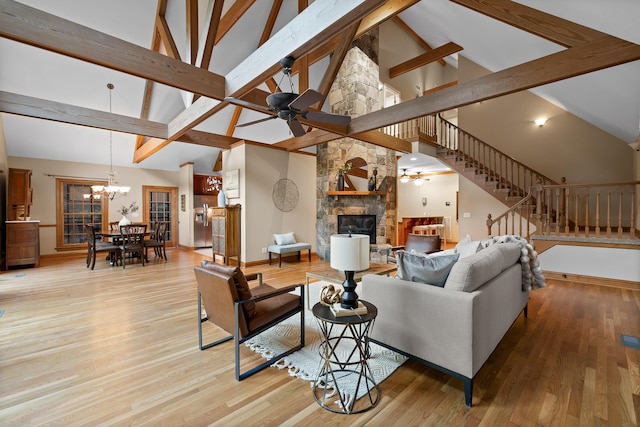 68 Bluff View Dr, Dunlap, TN 37327 - living room with high vaulted ceiling, stairs, ceiling fan, a stone fireplace, and a chandelier