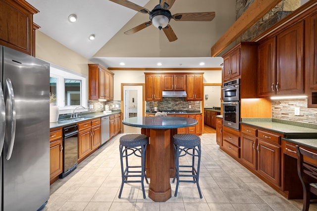68 Bluff View Dr, Dunlap, TN 37327 - kitchen with appliances with stainless steel finishes, decorative backsplash, under cabinet range hood, a kitchen breakfast bar, and a ceiling fan