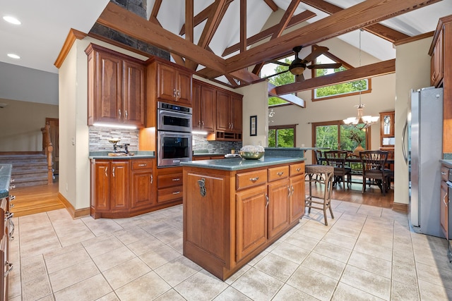 68 Bluff View Dr, Dunlap, TN 37327 - kitchen featuring appliances with stainless steel finishes, a ceiling fan, tasteful backsplash, light tile patterned floors, and dark countertops