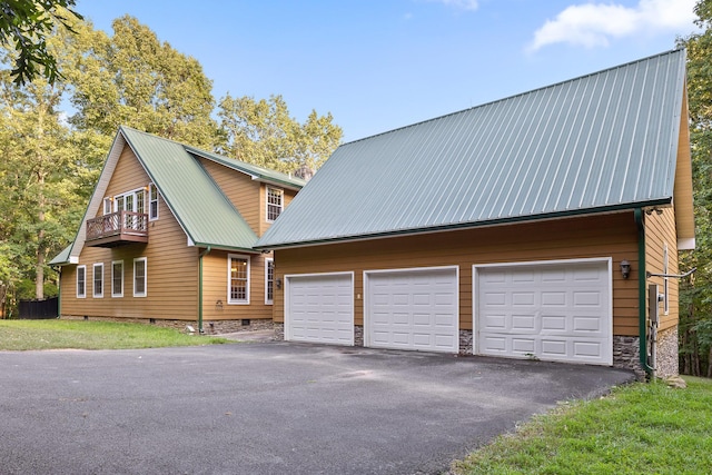 68 Bluff View Dr, Dunlap, TN 37327 - view of side of property featuring a garage, a metal roof, an outbuilding, a balcony, and asphalt driveway