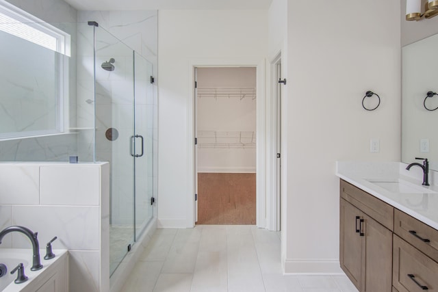 101 Lemonade St, Chattanooga, TN 37421 - bathroom featuring a shower stall, vanity, a walk in closet, and a garden tub